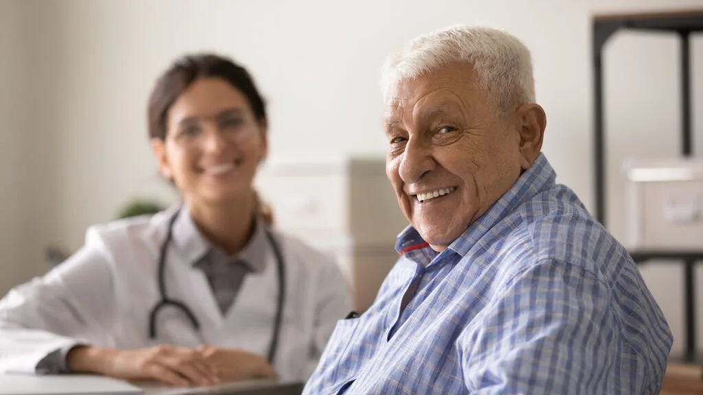 Smiling man during appointment at doctor's office.